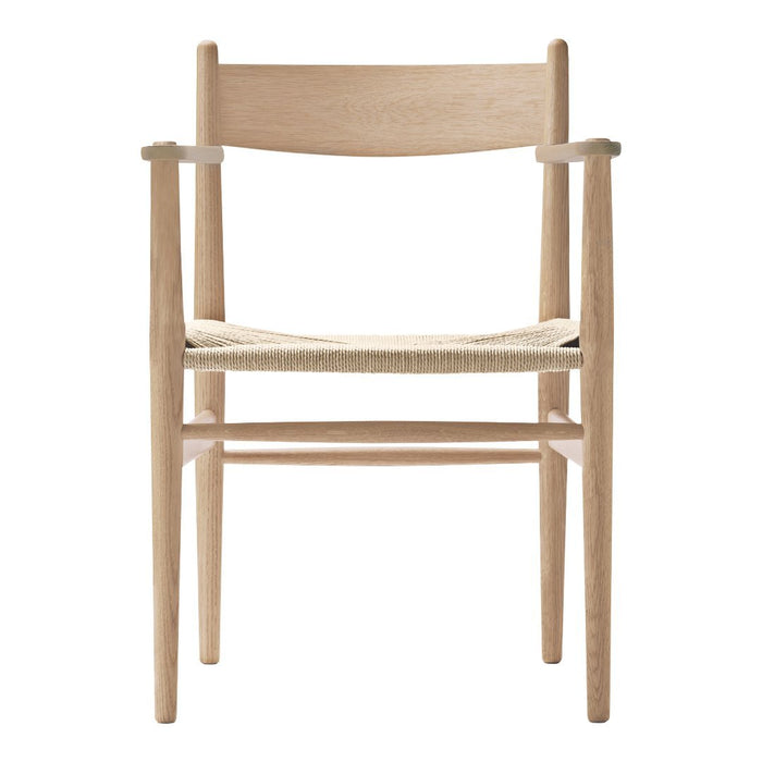 Natural wood armchair with a light finish and woven seat, showcasing minimalist design and neutral tones.