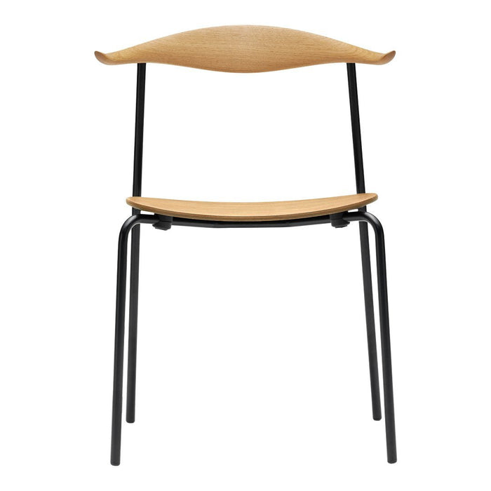 Natural wood grain finish with a smooth, curved top and sleek black metal legs. Modern minimalist design.