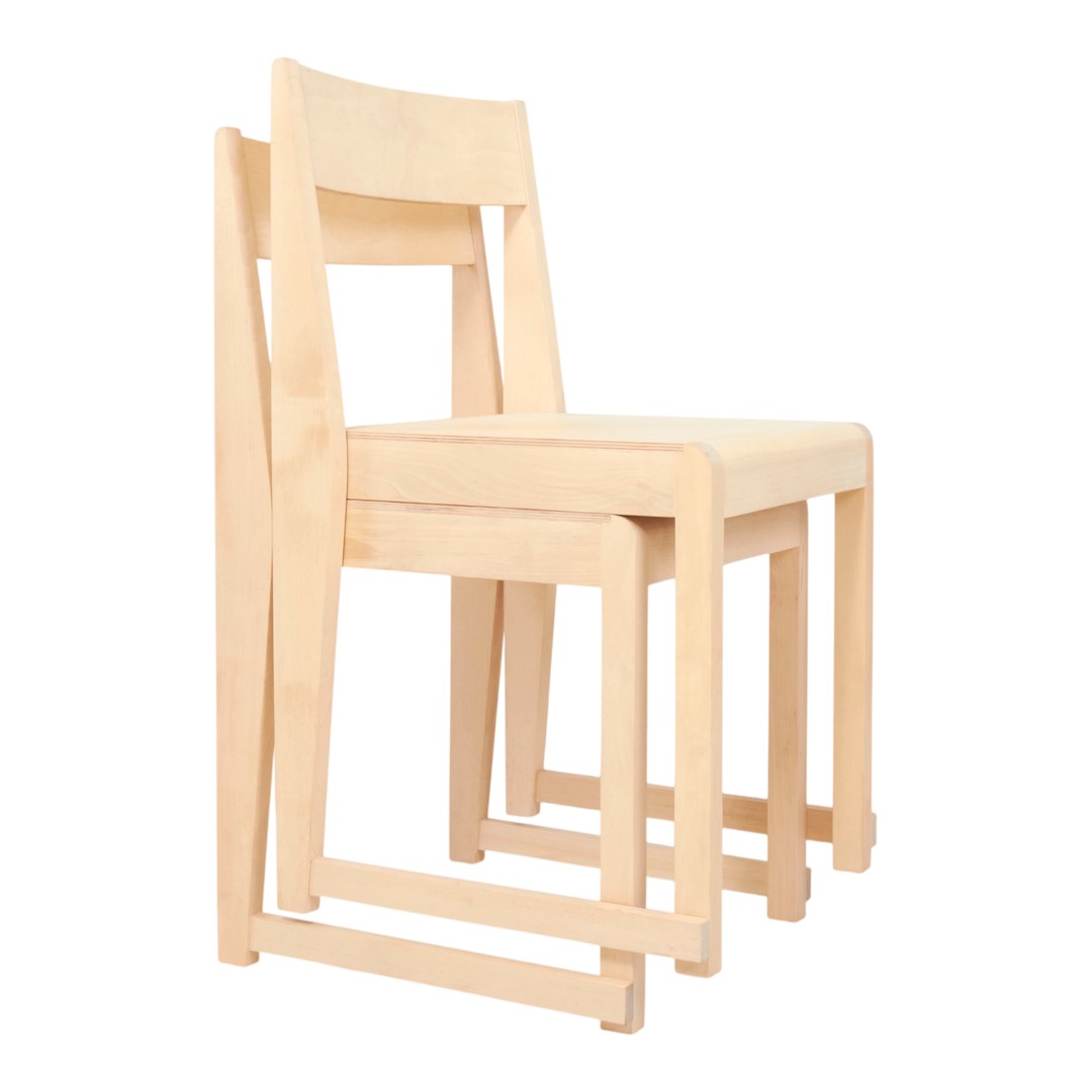 Light wooden chairs with a minimalist design, featuring a smooth, natural finish and no visible patterns.