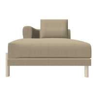 Beige chaise lounge with a modern design and subtle square armrest, featuring a smooth, textured fabric finish.