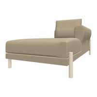 Beige upholstered chaise lounge with smooth fabric and white wooden legs, perfect for modern interiors.