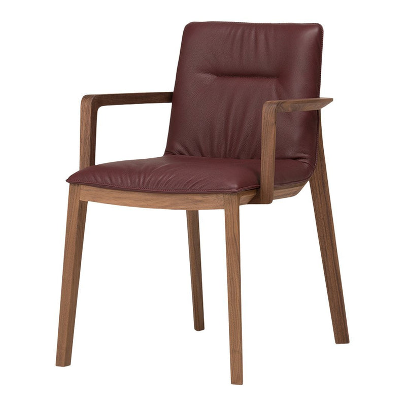 Burgundy leather armchair with smooth texture and a natural wood frame showcasing a minimalist design.