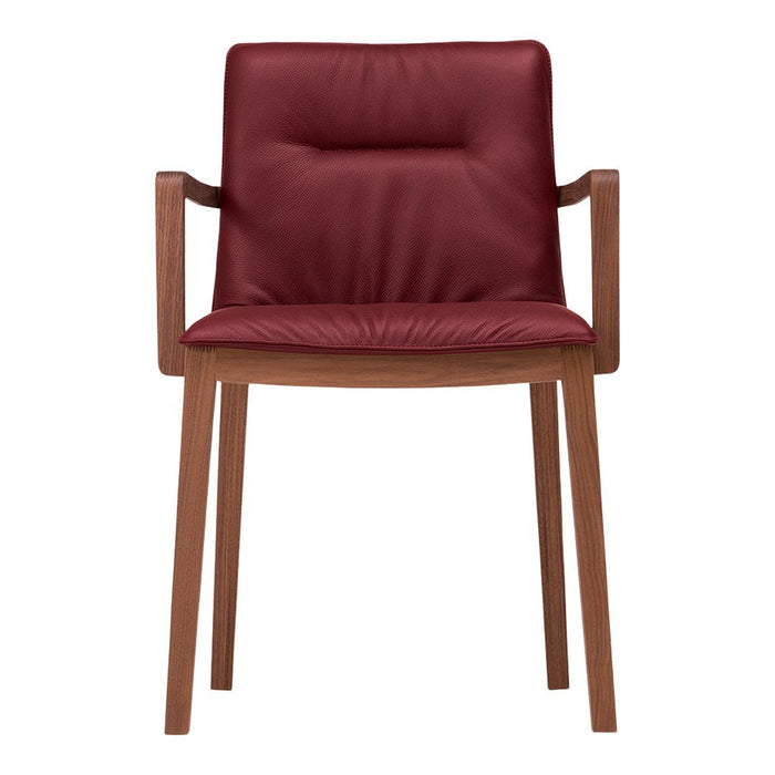 Burgundy upholstered chair with smooth texture, featuring a minimalistic design and wooden legs. Elegant and modern style.