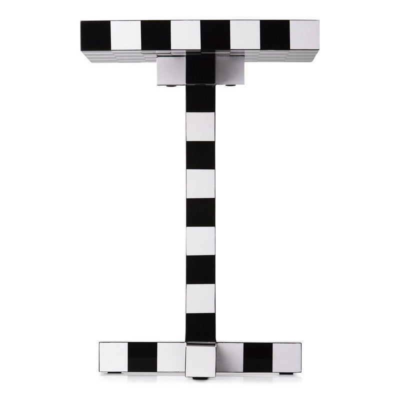 Black and white striped patterned side table with a modern geometric design.