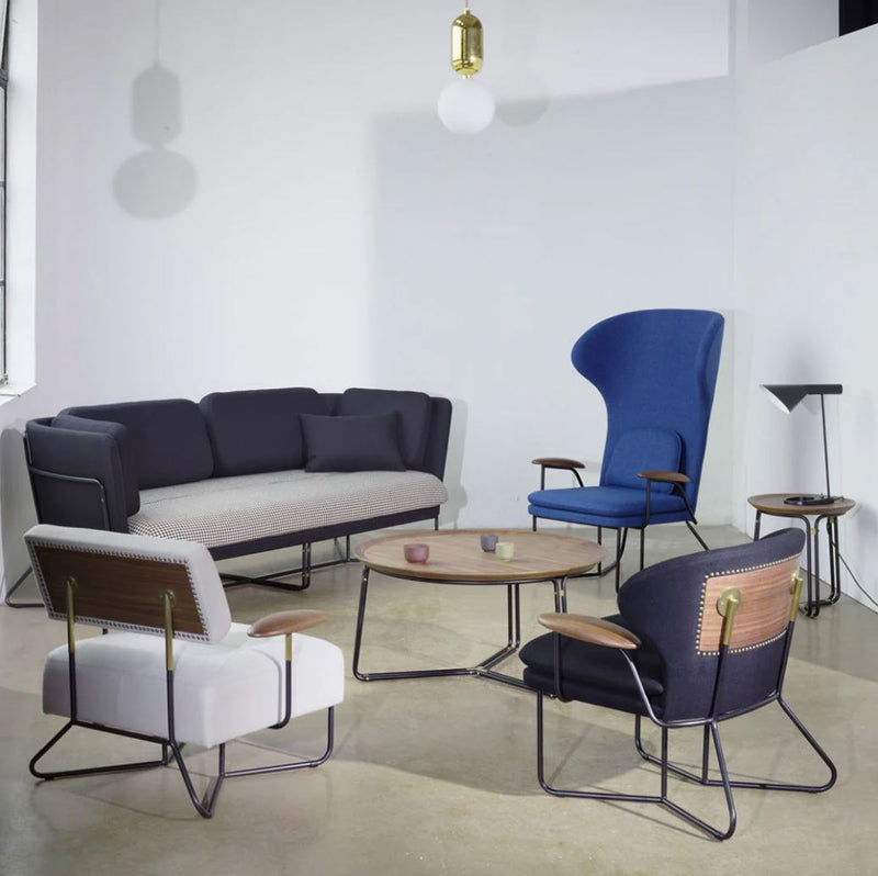 Modern seating set featuring gray, navy blue, and white upholstery with wooden accents on stylish metal frames.