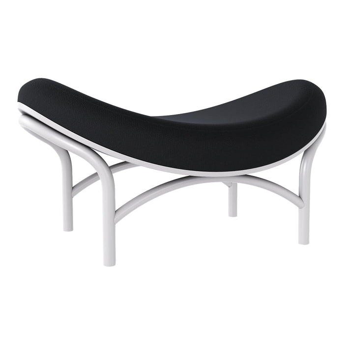 Black curved ottoman with sleek white metal legs, featuring a minimalist and modern design.