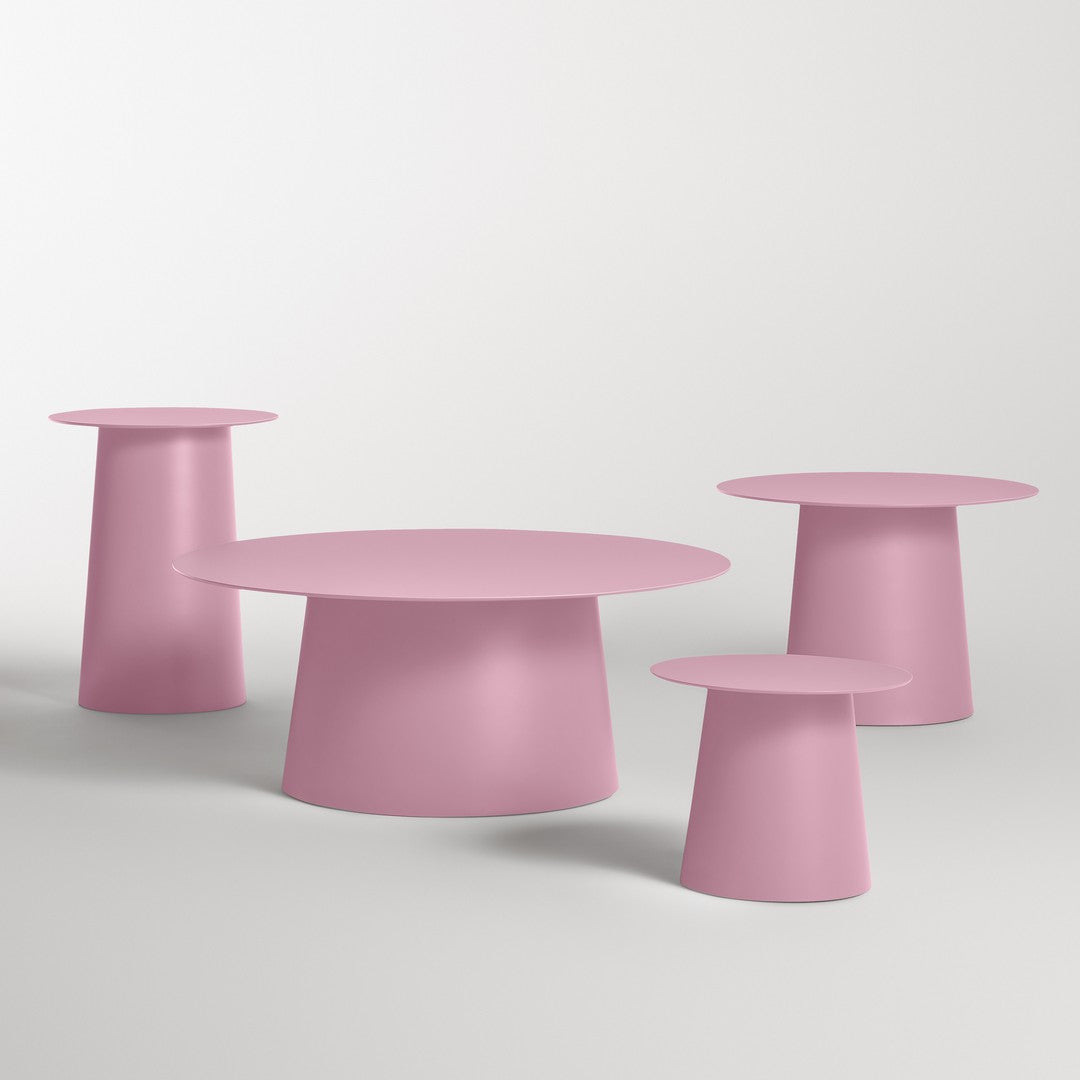 Set of four pink modern tables with smooth surfaces and varied heights, perfect for contemporary decor.