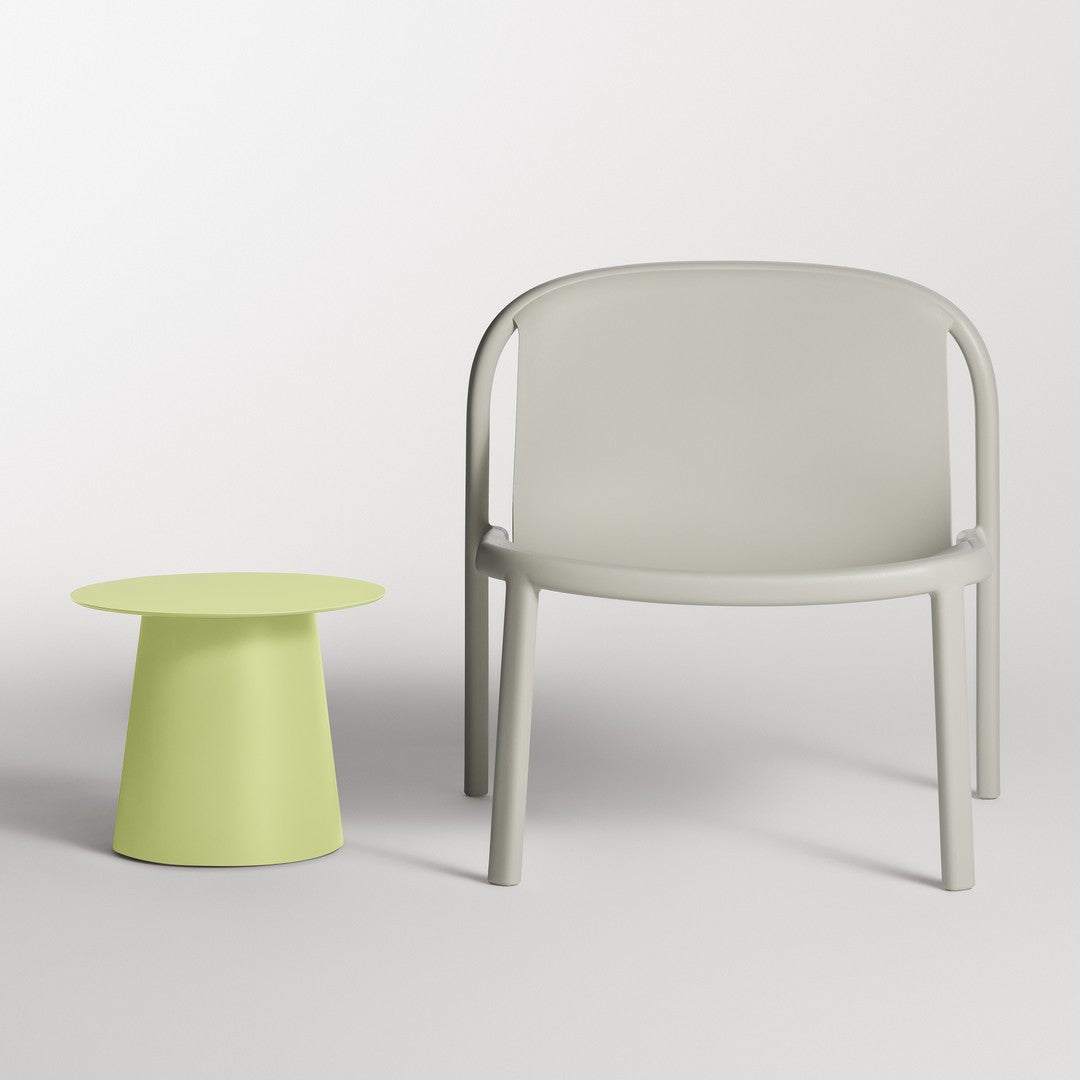 Light gray armchair paired with a vibrant lime green side table, showcasing a minimalist design and playful color contrast.