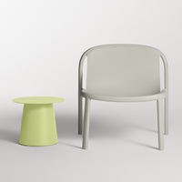 Light gray armchair paired with a vibrant lime green side table, showcasing a minimalist design and playful color contrast.