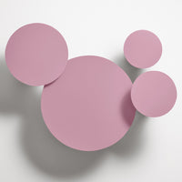 Pink circular wall decor with varying sizes and smooth matte finish. Ideal for modern, stylish interior accents.