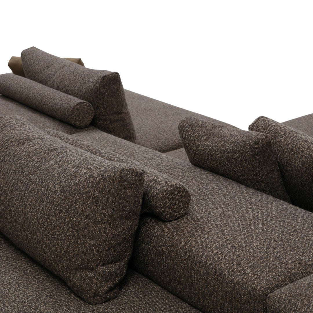 Textured brown sofa with coordinating accent pillows featuring a subtle, contemporary pattern.