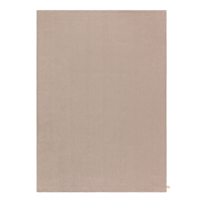 Solid beige area rug with a smooth texture, perfect for neutral color schemes and modern decor.