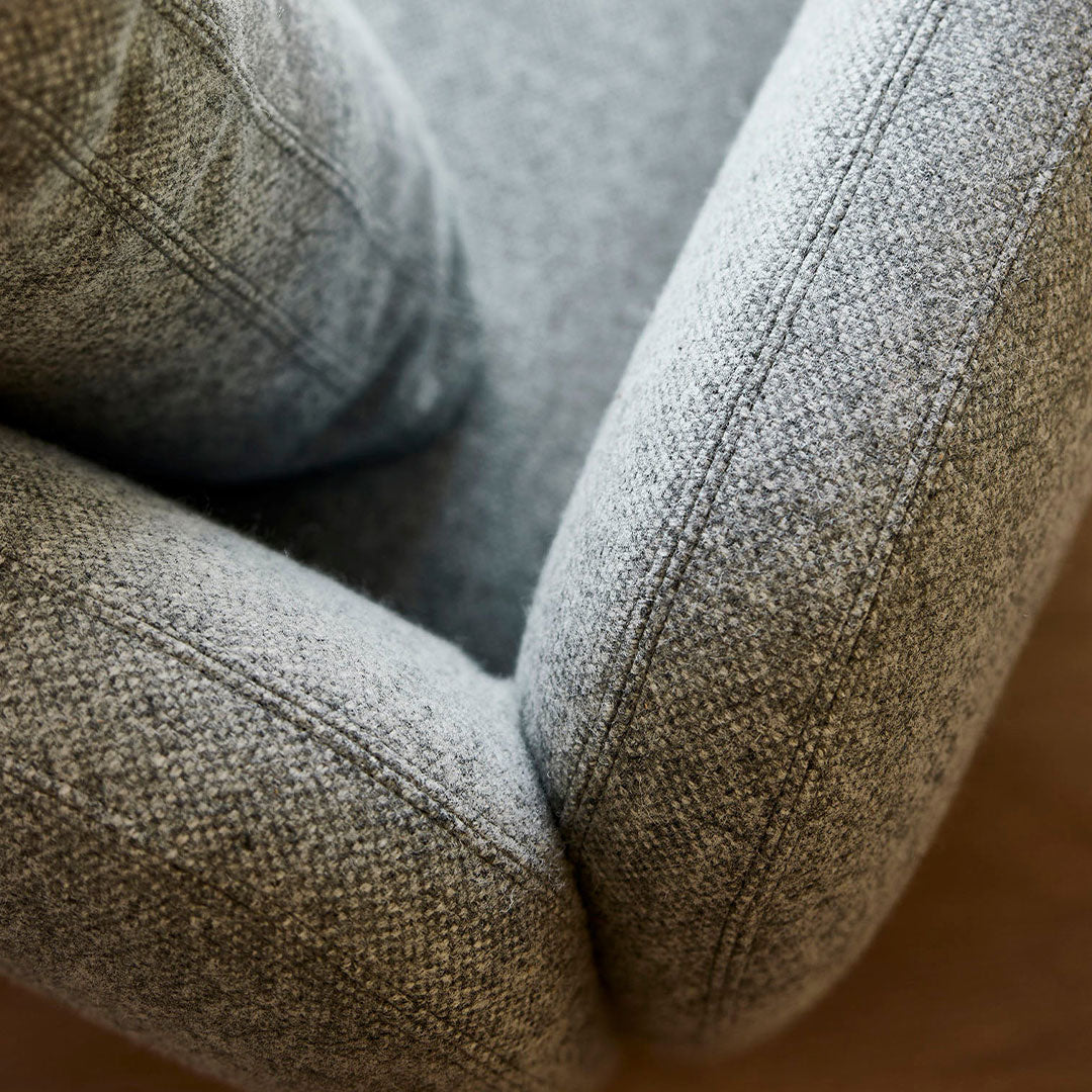Gray textured fabric with subtle herringbone pattern, showcasing a soft and inviting design aesthetic.
