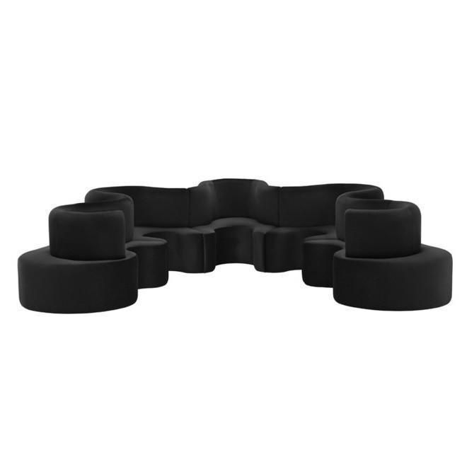 Modern black modular sofa with unique curved shapes and smooth, matte finish. Ideal for contemporary interiors.