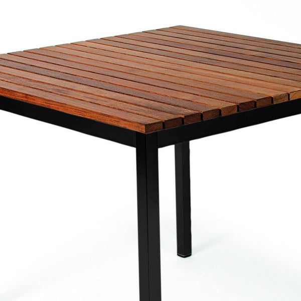 Square wooden table with a striped mahogany surface and sleek black metal legs.