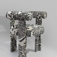 Black and white patterned chair with abstract designs and rounded edges, adding a modern touch to any space.