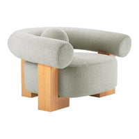 Curved armchair in soft sage green with textured upholstery and natural wood legs, featuring a modern minimalist design.