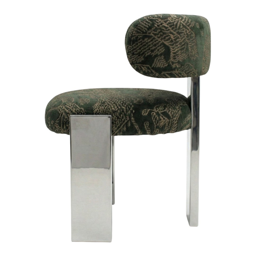 Green patterned chair with a chrome leg, featuring an abstract floral design on plush upholstery.
