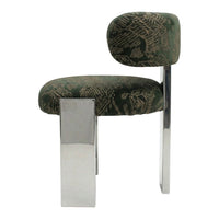 Green patterned chair with a chrome leg, featuring an abstract floral design on plush upholstery.