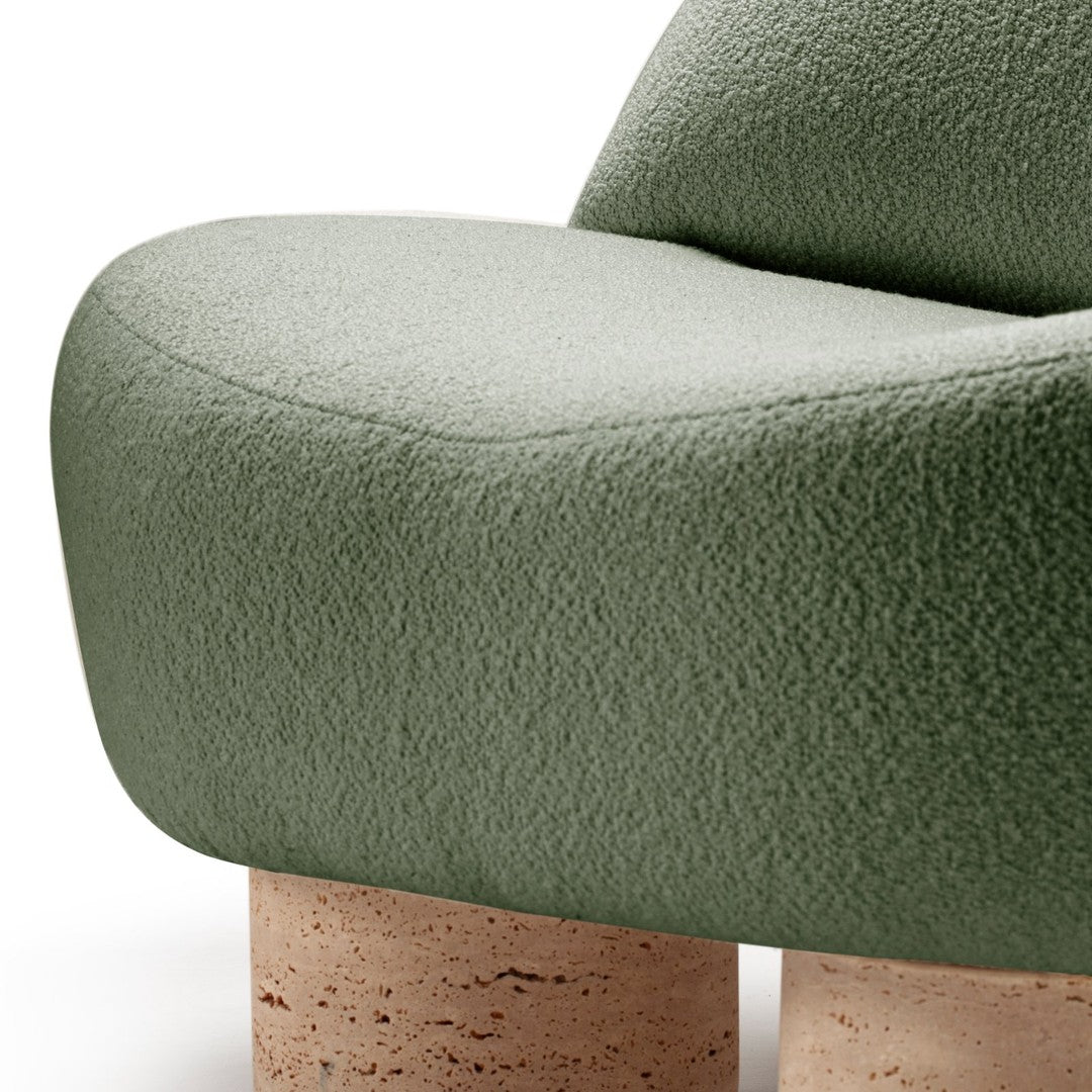 Soft green textured upholstery with smooth, rounded lines and natural cork legs, perfect for modern decor.