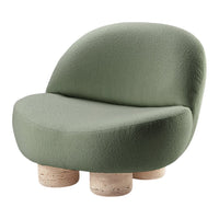 Soft green upholstered chair with curved shapes and minimalist beige cork legs. Ideal for modern, stylish interiors.
