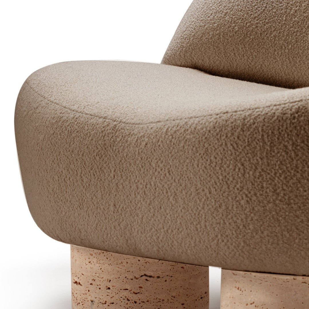 Soft beige textured upholstery with rounded curves and light speckled cork legs. Modern minimalist design.