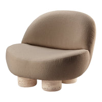 Soft beige chair with a rounded silhouette and textured fabric, resting on light, cylindrical stone legs.