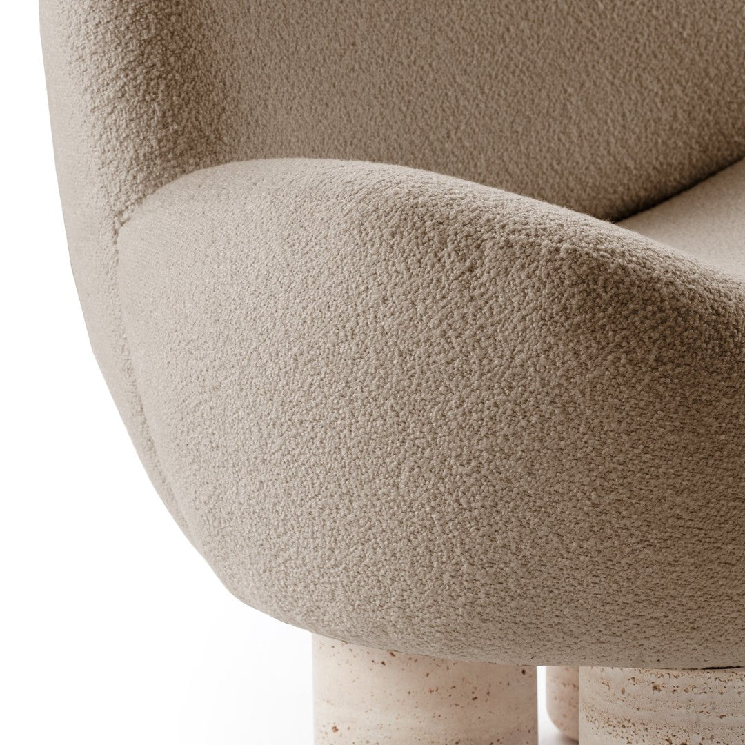 Beige textured upholstery with a soft, cozy appearance, paired with smooth light-colored, rounded legs.