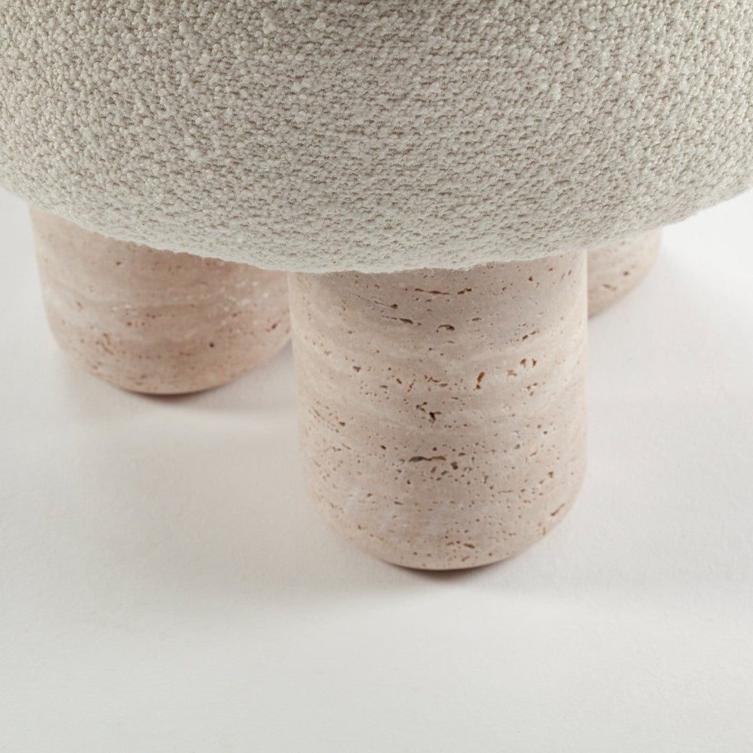 Textured white surface with soft pink, speckled cylindrical legs. Modern and minimalistic design.
