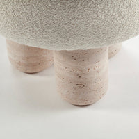 Textured white surface with soft pink, speckled cylindrical legs. Modern and minimalistic design.