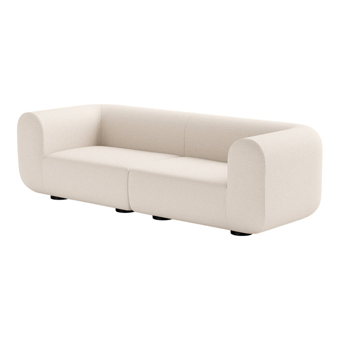 Soft cream-colored sofa with a smooth, minimalist design and rounded edges, perfect for modern decor.
