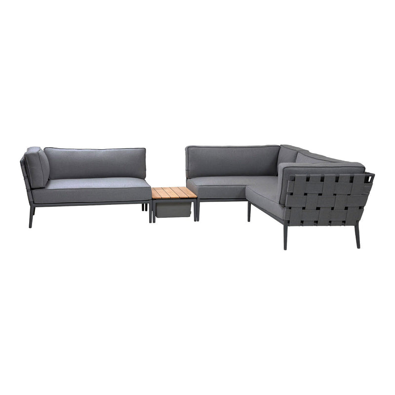 Modern gray sectional sofa with tufted upholstery and a wooden coffee table, ideal for outdoor or indoor settings.