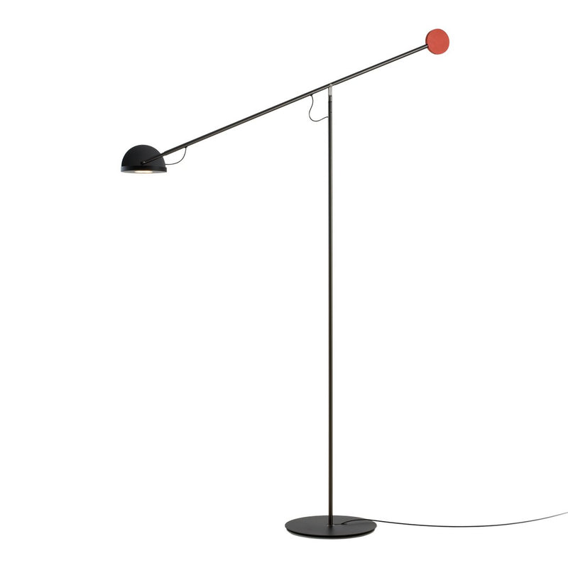 Modern floor lamp featuring a black base and shade with a bright red accent. Sleek, minimalist design perfect for contemporary decor.