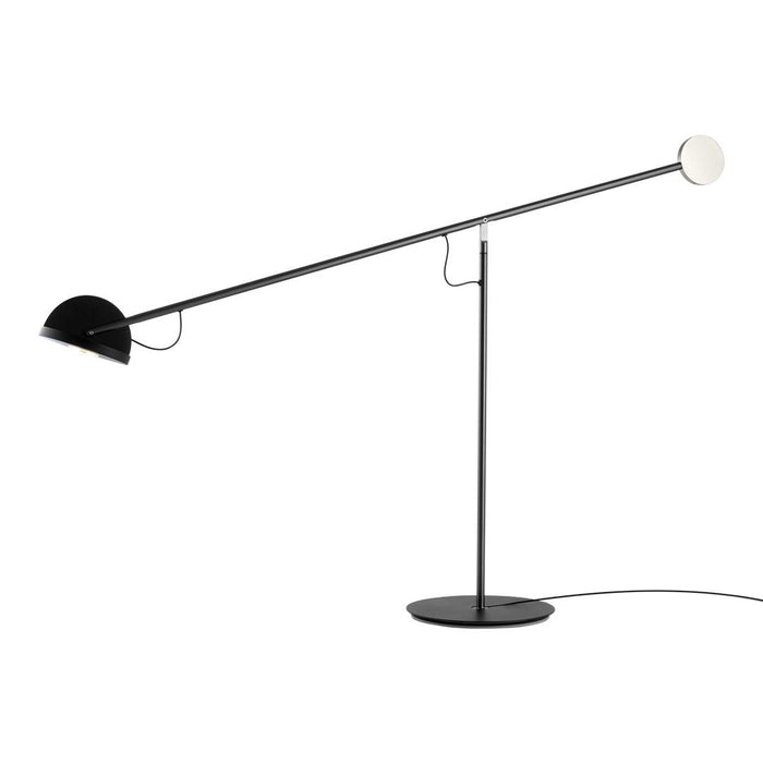 Sleek black lamp with a minimalist design featuring a round white light and smooth black base. Ideal for modern decor.