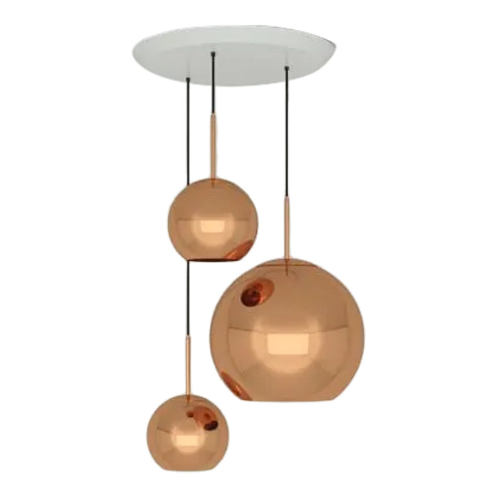 Three glossy copper pendant lights with a sleek white ceiling mount, showcasing a modern and elegant design.