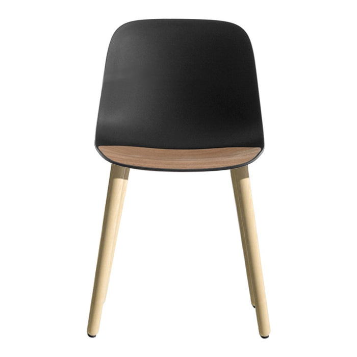 Black chair with a smooth surface and natural wood legs, showcasing a modern, minimalist design.