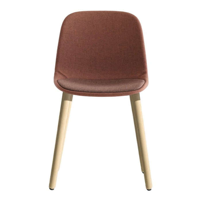 Rust-colored upholstered chair with natural wood legs, featuring a sleek, minimalist design.