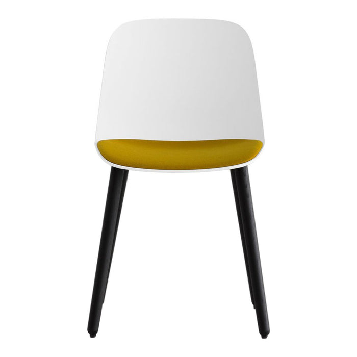Modern chair featuring a white exterior with a vibrant yellow interior and sleek black legs. Ideal for contemporary decor.