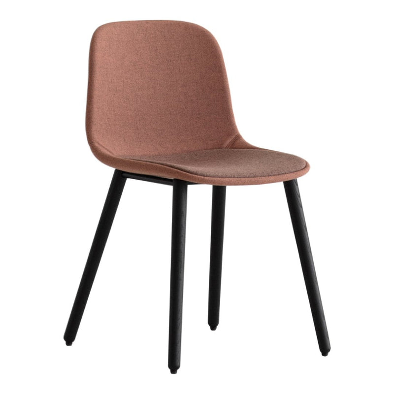 Soft pink upholstered chair with sleek black legs, featuring a minimalist design perfect for modern decor.