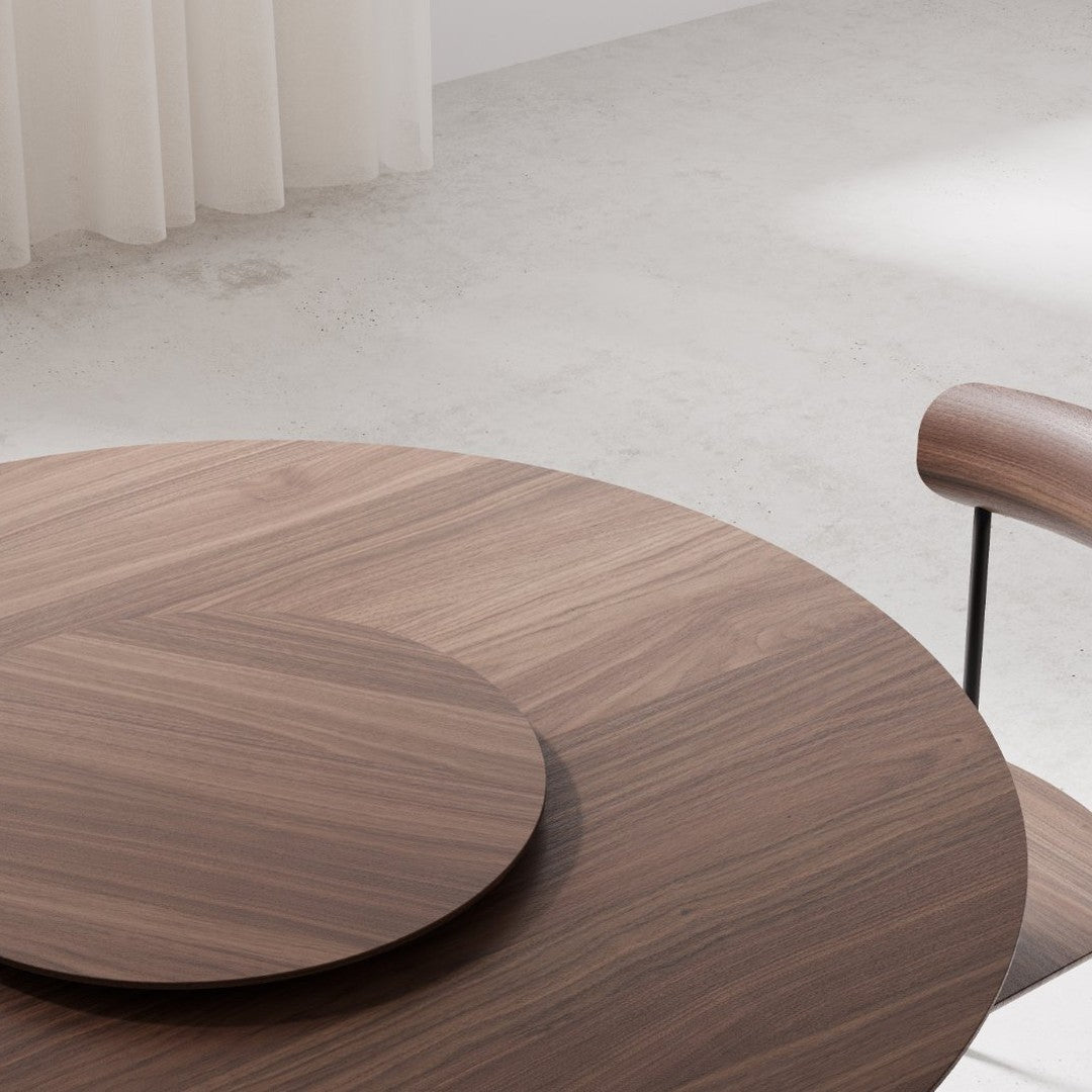 Round wooden table with rich brown tones and sleek surface pattern, featuring a circular inset. Modern and elegant design.