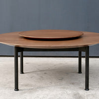 Round wooden coffee table with a rich brown finish and sleek black metal legs, featuring a modern two-tier design.