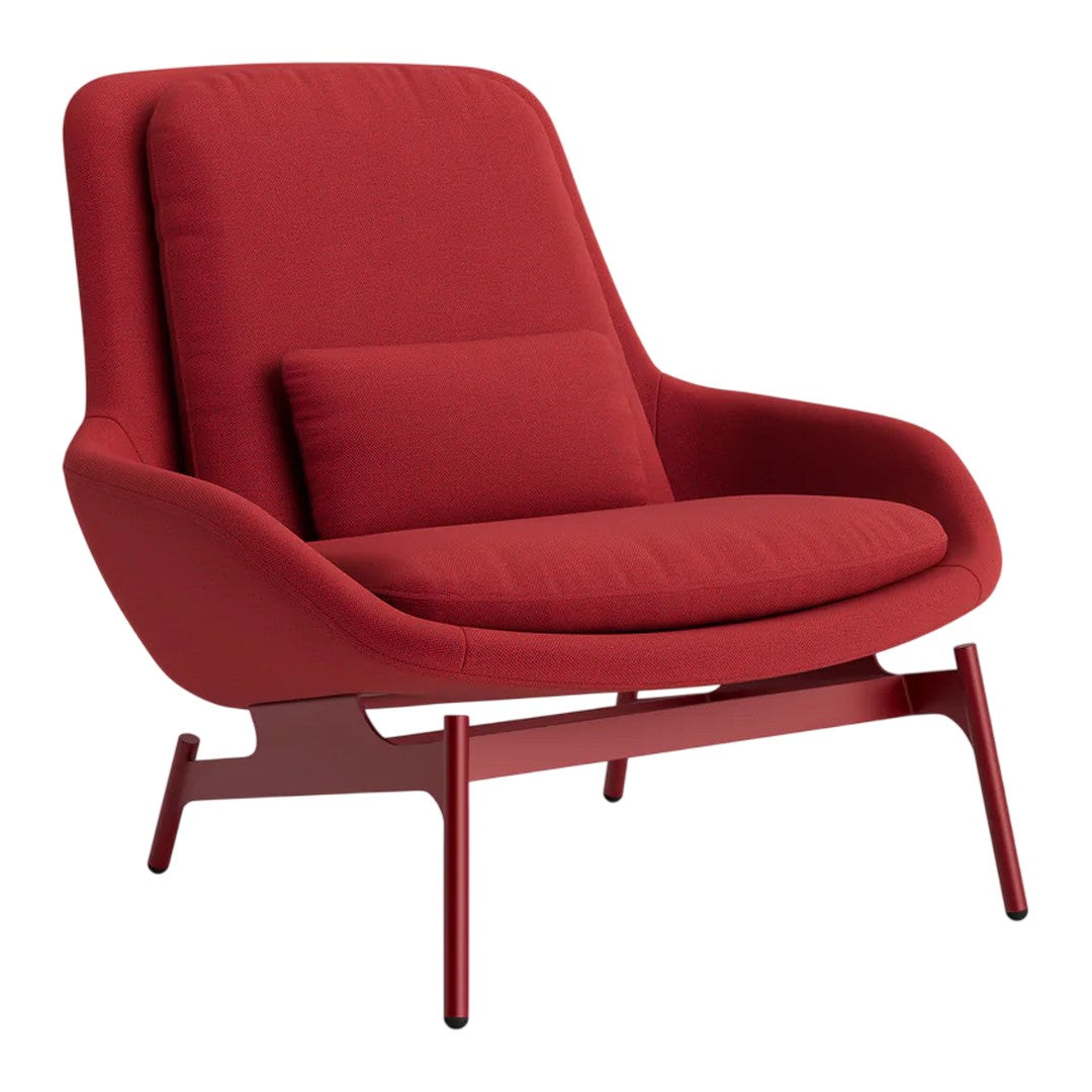 Red upholstered lounge chair with a smooth, modern design and matching cushion. Sleek, minimalist legs complete the look.