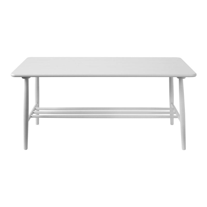 White rectangular coffee table with a smooth surface and minimalist design, featuring slender legs and a lower shelf.