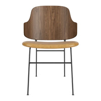 Wooden chair featuring a walnut backrest and a light tan seat, complemented by sleek black metal legs.