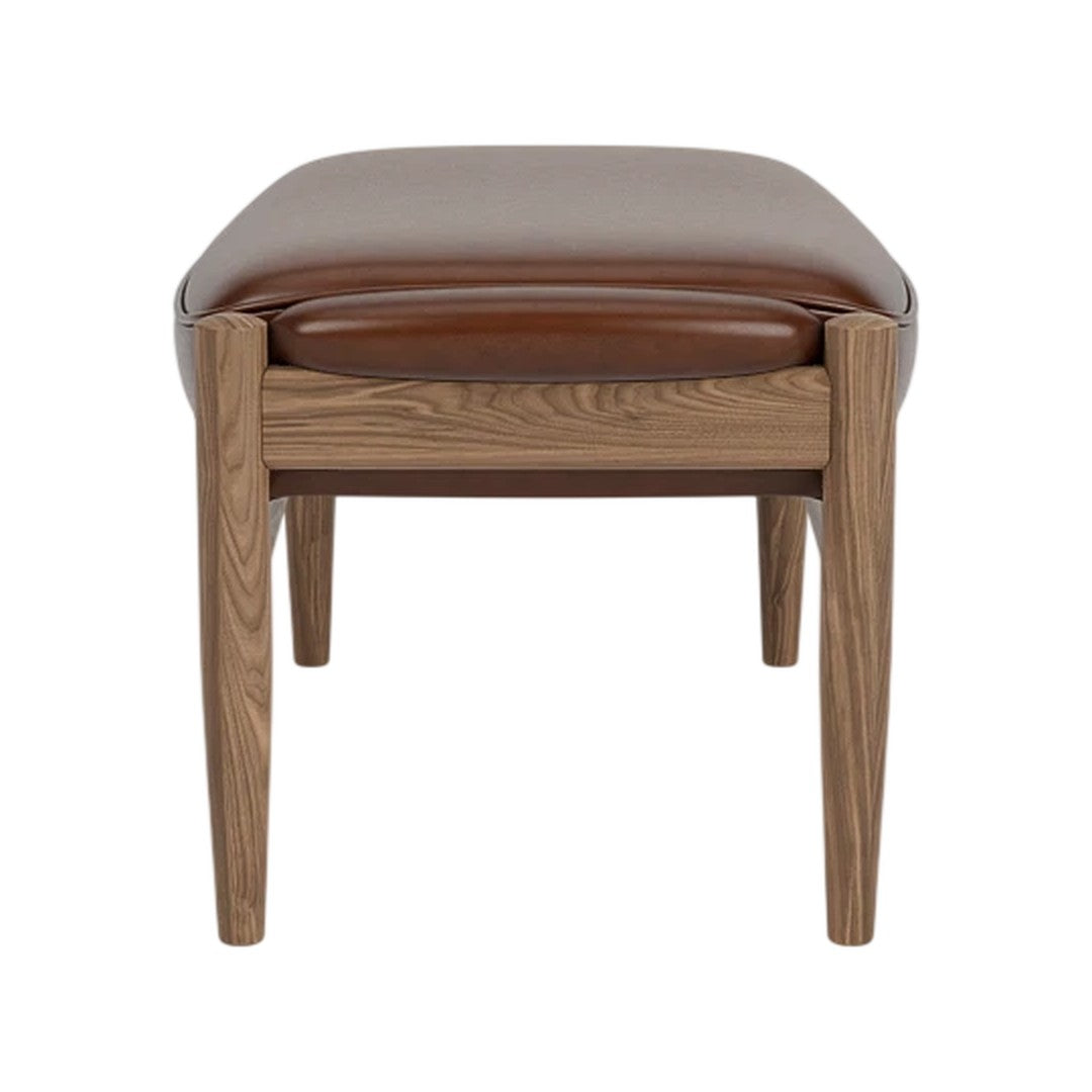 Brown leather ottoman with a smooth finish and wooden legs, featuring a sleek, minimalist design.