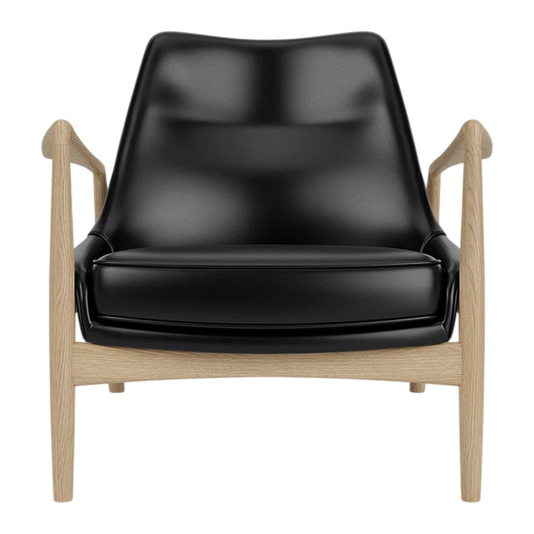 Black leather armchair with a minimalist design and light wooden frame. Modern and stylish home decor accent.