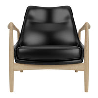 Black leather armchair with a minimalist design and light wooden frame. Modern and stylish home decor accent.