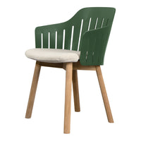 Green slatted chair with a light beige cushion and natural wood legs, perfect for modern decor.