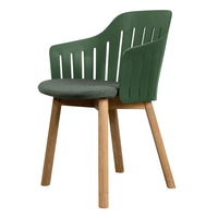 Green chair with slatted backrest and cushioned seat, featuring natural wood legs for a stylish contrast.
