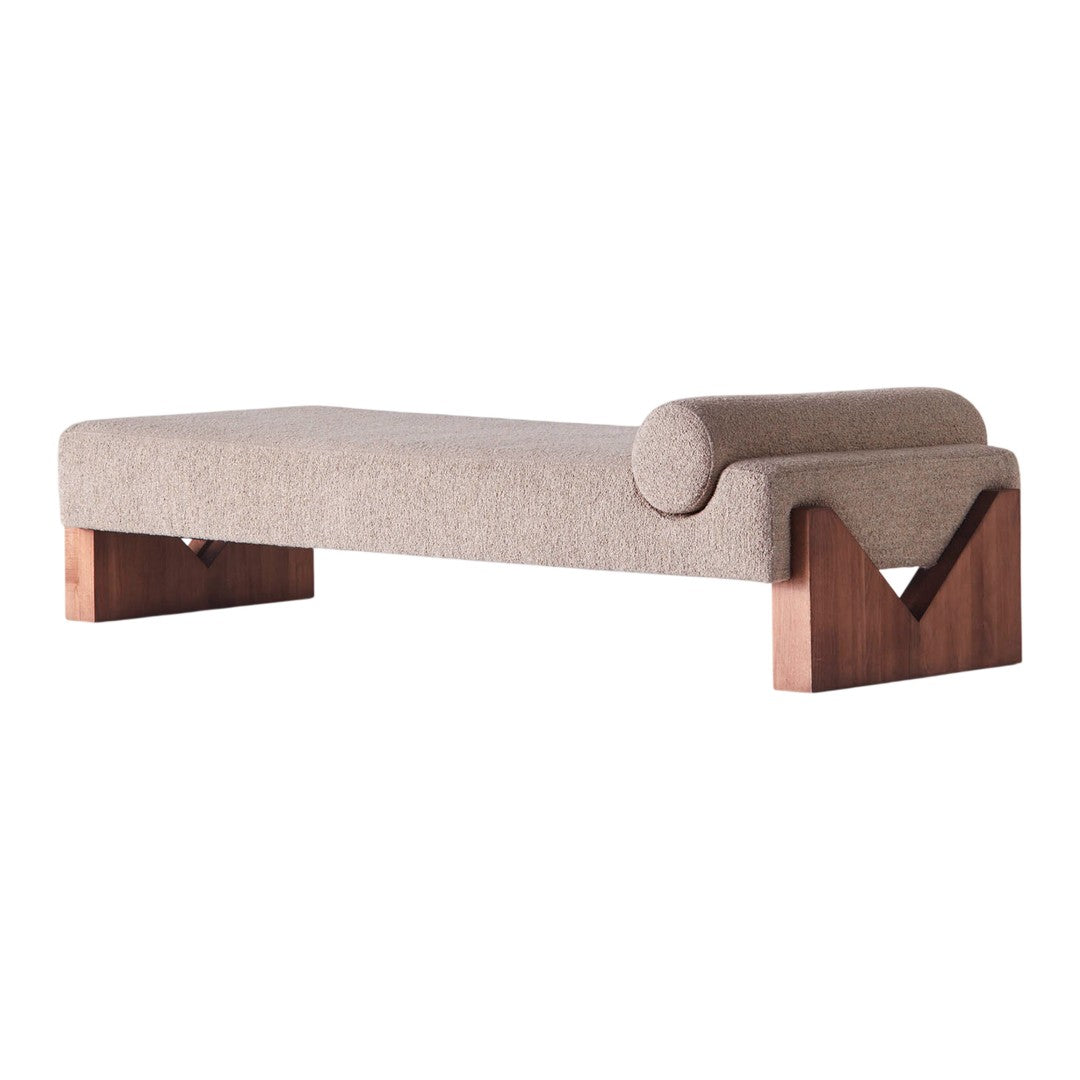 Neutral beige upholstery with smooth texture, complemented by rich wooden legs featuring geometric design.